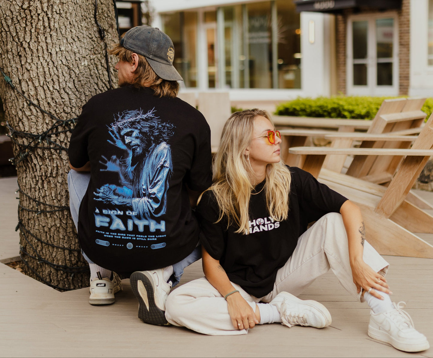 Two people posing at outdoors with a building in the background