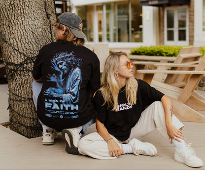 Two people posing at outdoors with a building in the background