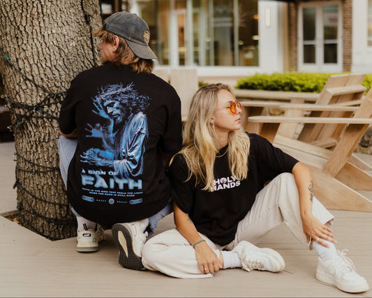 Two people posing at outdoors with a building in the background